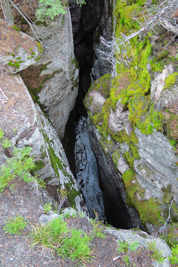 snow at the bottom of a deep crack [Cougar Flat Overlook, Okanogan-Wenatchee National Forest, Yakima County, Washington]